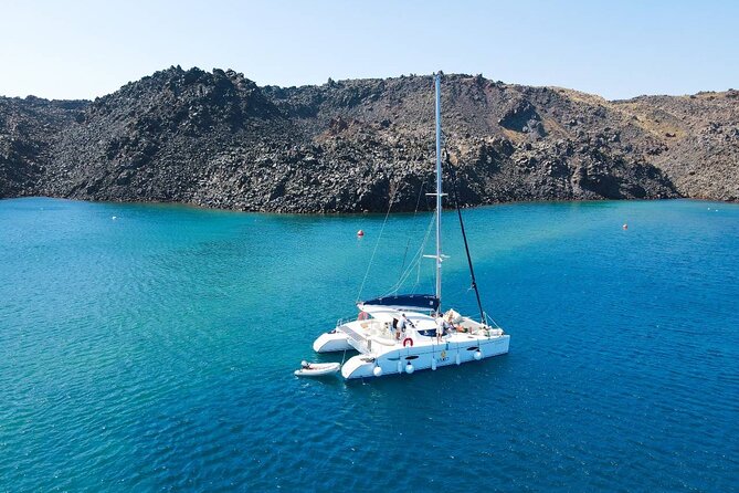 Best of Santorini Private Half-Day Catamaran Cruise with transfer and meal - Red Beach: dramatic rock, limited room