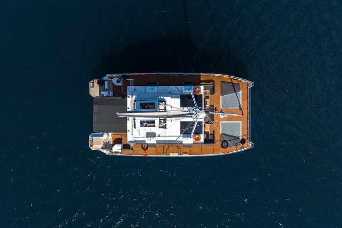 Comfort Max Catamaran Caldera Cruise with BBQ and Drinks - The volcano and Santorini’s dark volcanic coast