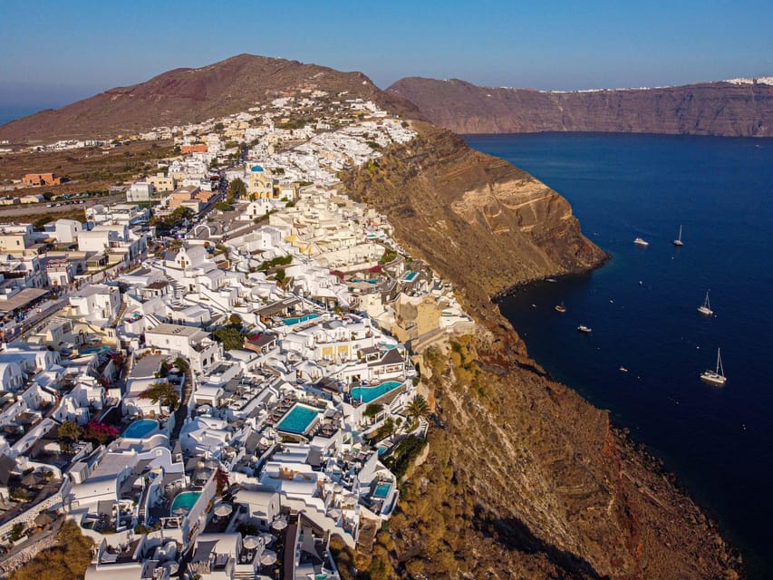 From Fira: Santorini Highlights Minibus Tour with Oia Sunset - Oia sunset is the payoff, with time to make it yours