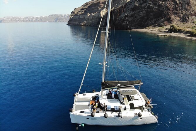 Half-Day Exclusive Catamaran Cruise in Santorini with Meal and Open Bar - Red Beach and Santorini’s volcanic colors