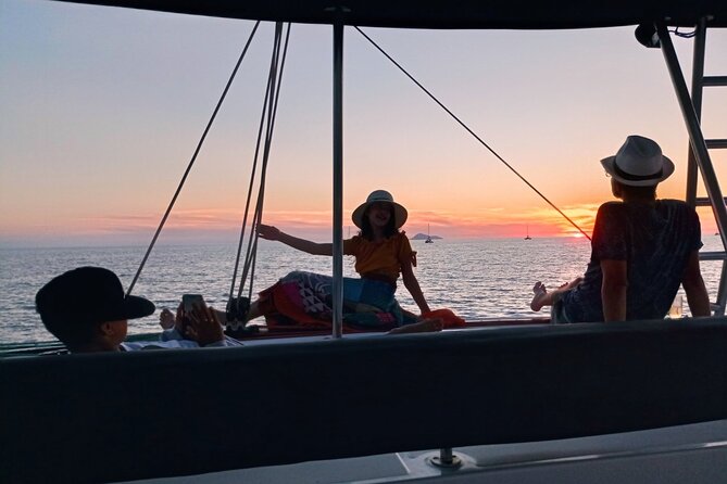 Half-Day Exclusive Catamaran Cruise in Santorini with Meal and Open Bar - The catamaran itself and the atmosphere onboard