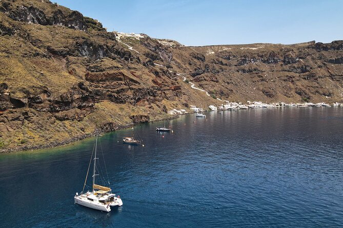Luxury Santorini Sunset Cruise: Dinner, BBQ, Open Bar, Transfers - Sailing past Red Beach, White Beach, and Akrotiri