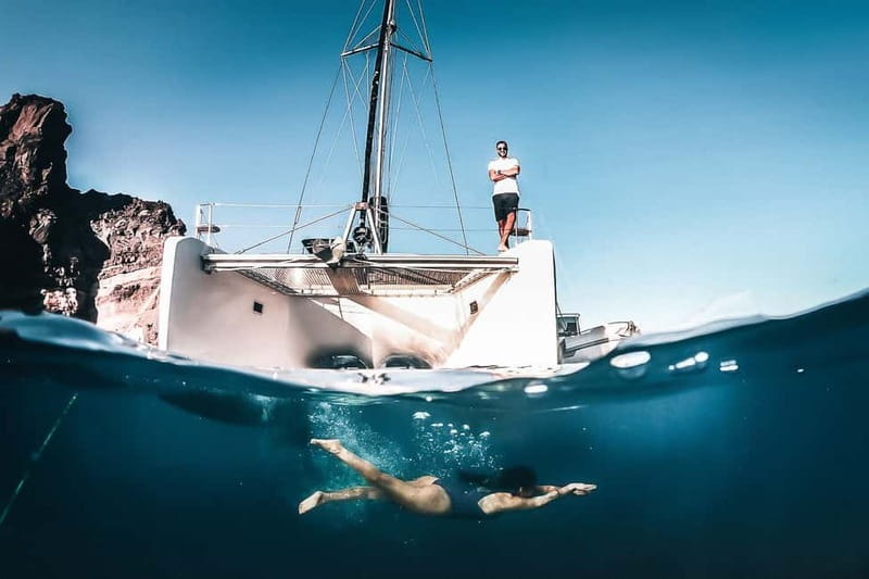 Santorini: All-Inclusive Private Catamaran Experience - Red Beach, White Beach, and Black Mountain from the water