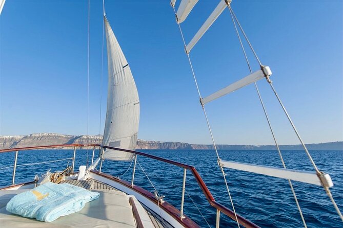 Santorini Caldera Day Traditional Cruise with Meal and Drinks - Arriving beneath Oia at Ammoudi Bay
