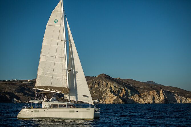 Santorini Caldera Gold Day Cruise with BBQ on board and Open Bar - White Beach and the Akrotiri lighthouse