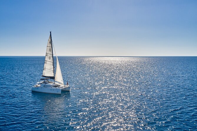 Santorini: Caldera Private Catamaran Cruise with Meal & Drinks - The lighthouse and Santorini’s southern edge