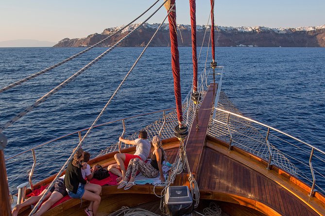 Santorini Caldera Sunset Sailing Cruise with Dinner and Wine - Sunset near Oia from the water