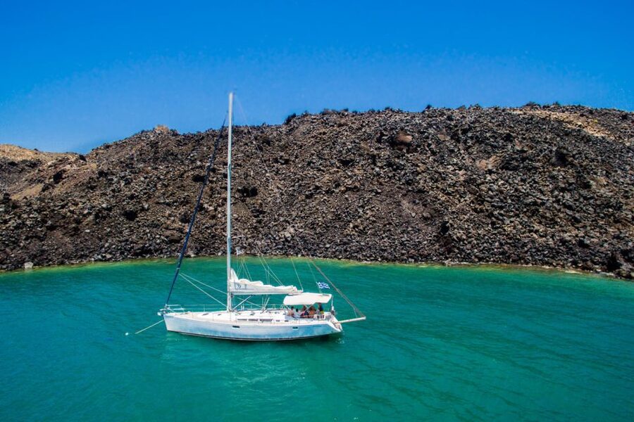 Santorini Caldera: Sunset Sailing Cruise with Meal - White Beach and the southern coast