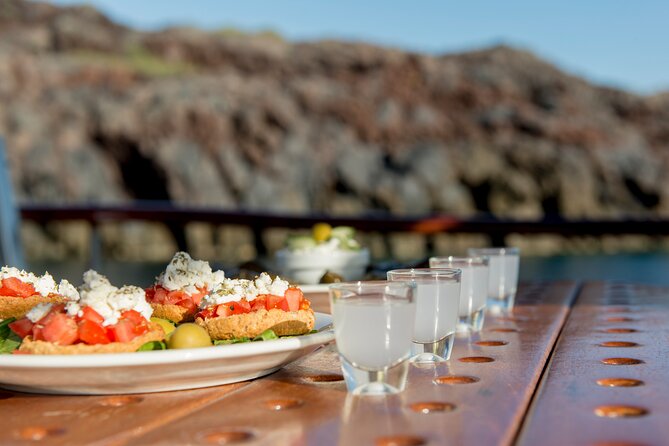 Santorini Caldera Sunset Traditional Cruise with Meal and Drinks - Mesa Pigadia and the Akrotiri Lighthouse