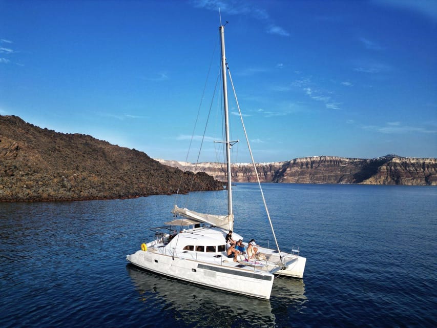 Santorini: Catamaran Cruise with Greek BBQ and Drinks - Red Beach, where Santorini shows its colors