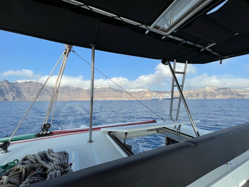 Santorini Catamaran Cruise with Swimming, Meal and Open Bar - Akrotiri Lighthouse and the southern Caldera
