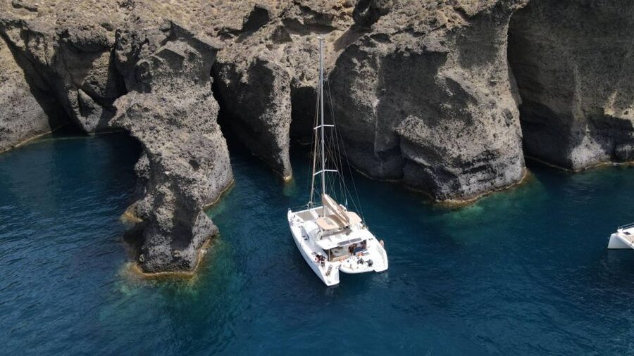 Santorini Catamaran Day Cruise: Lunch, Drinks and Transfers - Entering the Caldera and swimming at Nea Kameni