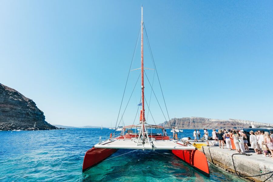 Santorini: Catamaran Tour with BBQ Dinner, Drinks, and Music - Red Beach and the first proper swim