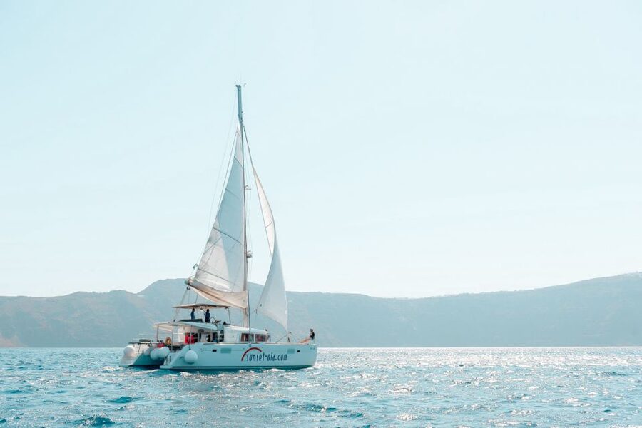Santorini: Catamaran Tour with BBQ Meal and Unlimited Drinks - Sailing past Aspronisi, Akrotiri, and Indian Rock