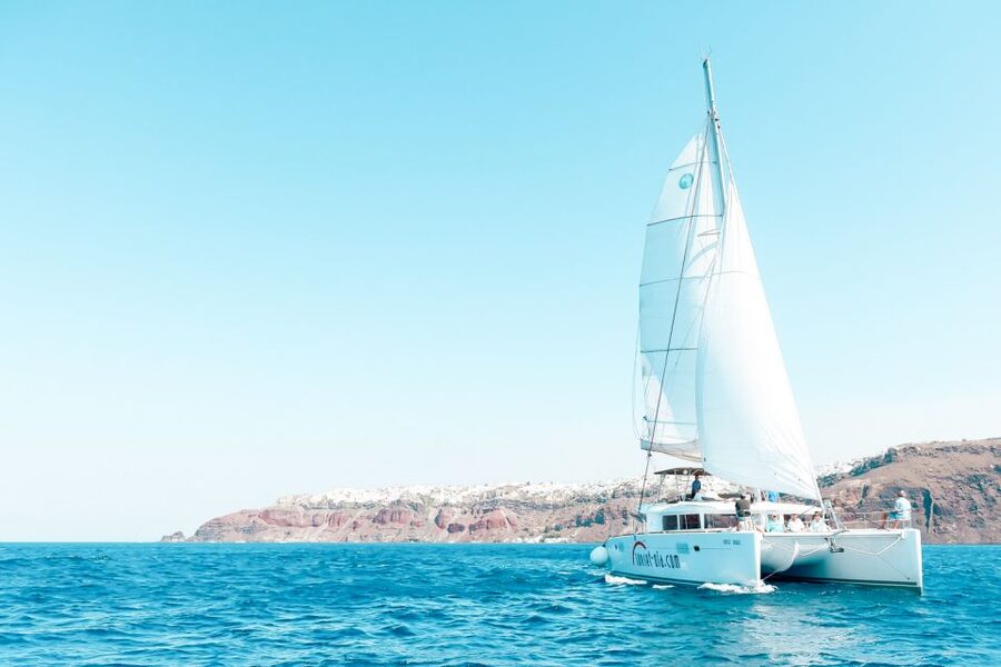 Santorini: Catamaran Tour with BBQ Meal and Unlimited Drinks - The sunset option and views below Oia