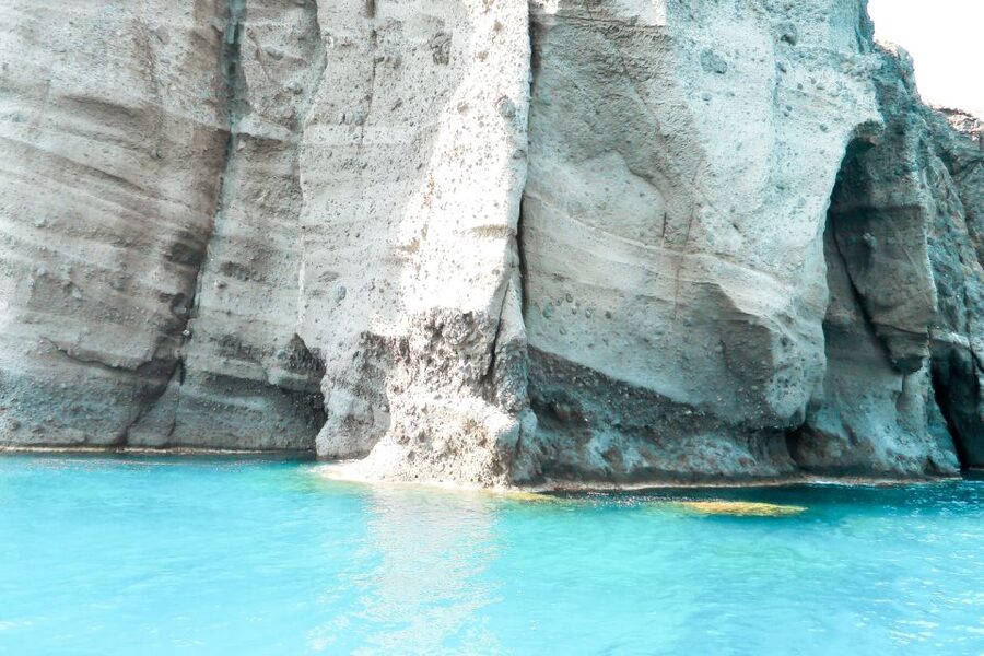 Santorini: Catamaran Tour with BBQ Meal and Unlimited Drinks - Pickup, ports, and the first hour aboard
