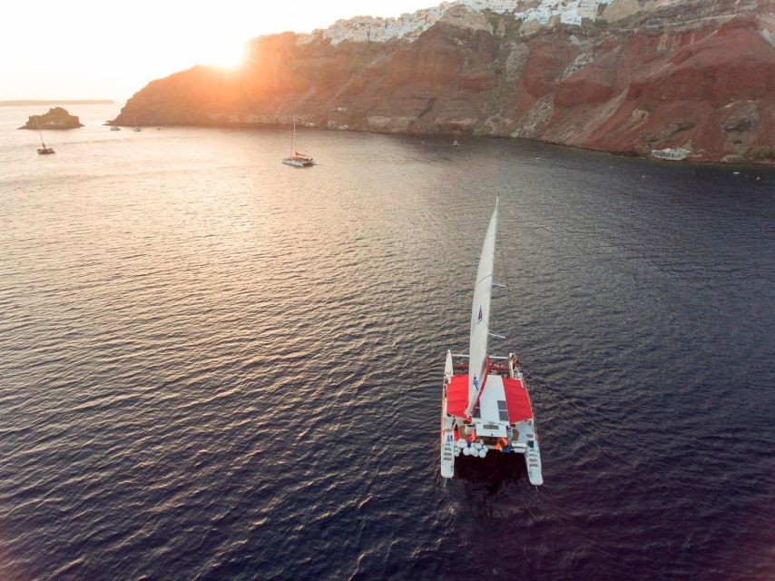 Santorini: Cruise Catamaran with BBQ & Drinks Day or Sunset - Fira and the old port from sea level