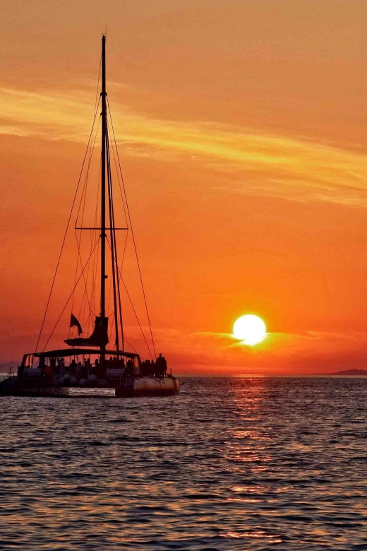 Santorini: Cruise Catamaran with BBQ & Drinks Day or Sunset - The sunset option below Oia