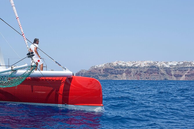 Santorini Cruise on Catamaran with BBQ & Open Bar - The route past the Old Lighthouse and Indian Rock