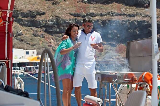 Santorini Cruise on Catamaran with BBQ & Open Bar - Stop three: White Beach, swimming, and lunch
