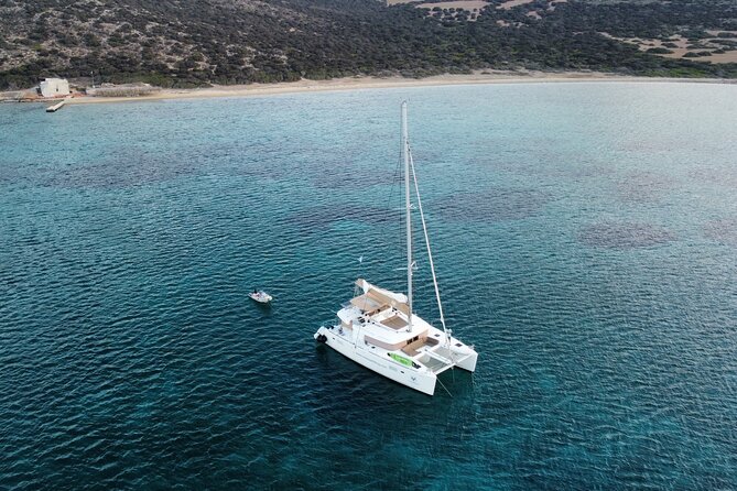 Santorini Gold Catamaran Cruise with BBQ, Drinks and Hotel Pickup - White Beach and the Lighthouse Near Akrotiri