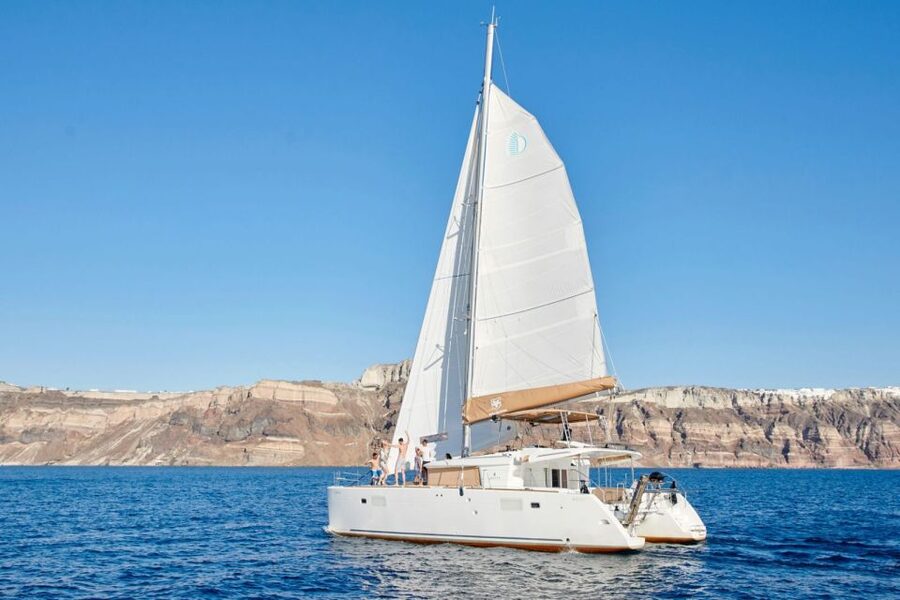 Santorini Gold Catamaran Cruise with Snorkel, BBQ & Open Bar - Caldera cliffs and villages from the sea