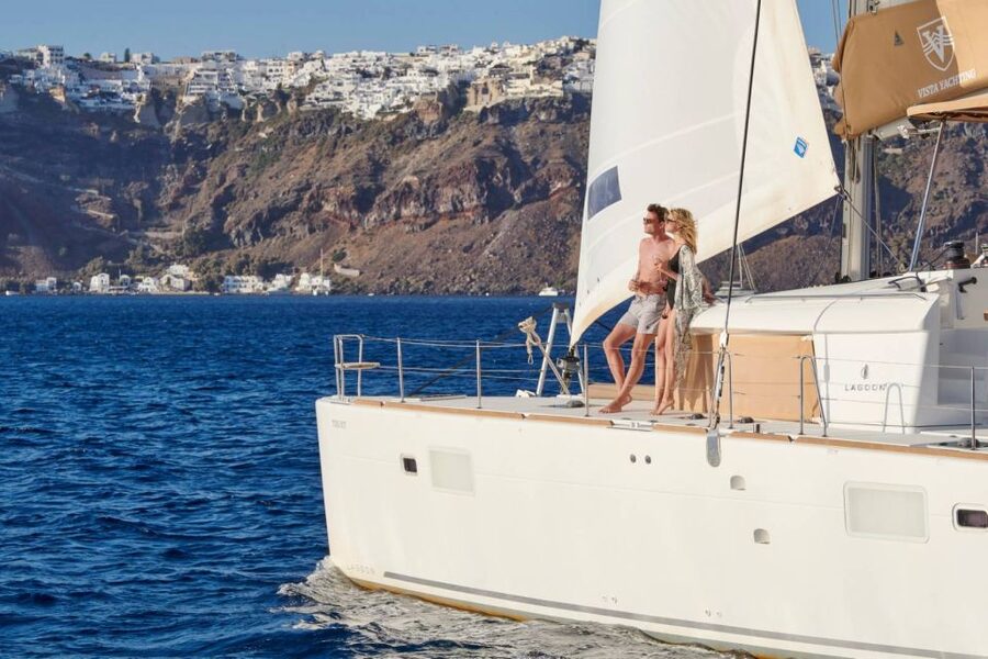 Santorini Gold Catamaran Cruise with Snorkel, BBQ & Open Bar - Leaving Vlychada Marina with meze on deck