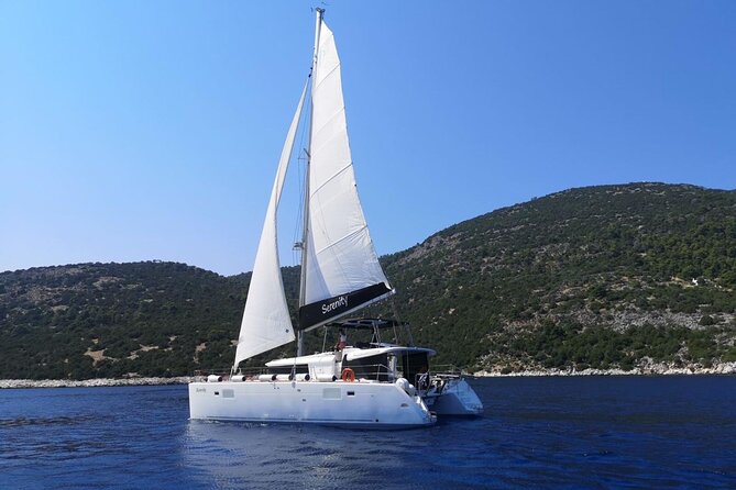 Santorini: Luxury Catamaran Cruise with Fresh Fish BBQ & Drinks - White Beach and the changing colors of the coast