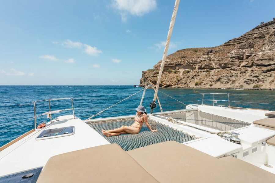 Santorini: Luxury Catamaran Day Trip with Meal and Open Bar - Santorini from the water, not the postcard crowd