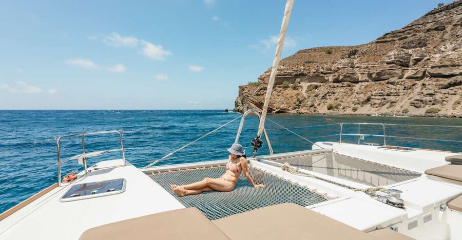 Santorini: Luxury Catamaran Day Trip with Meal and Open Bar - Pickup, port arrival, and the first hour aboard