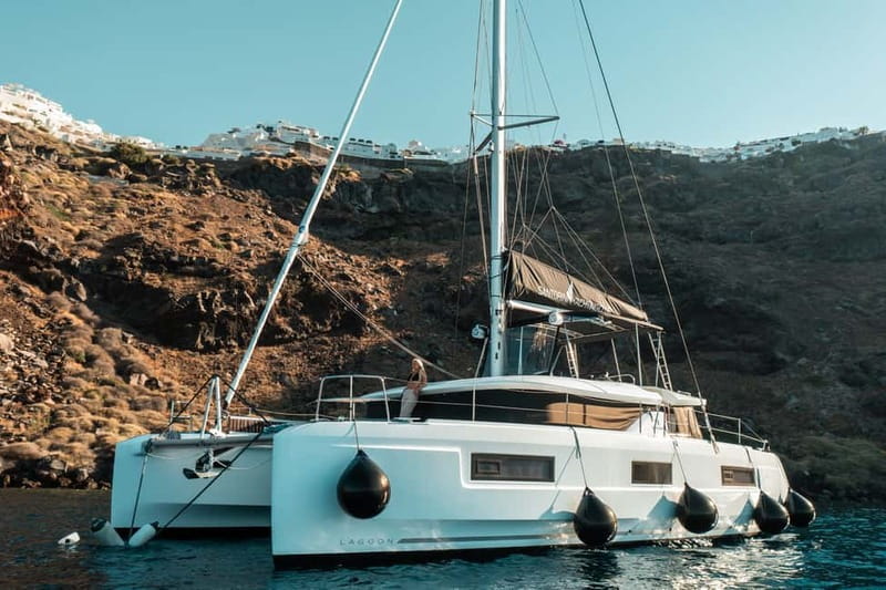 Santorini: Majestic Catamaran Cruise with Meal and Drinks - A roomy catamaran with Santorini scenery all around