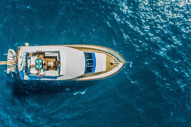 Santorini: Motor Yacht Sunset Cruise with 5-Course Dinner - Swimming and snorkeling at Mesa Pigadia