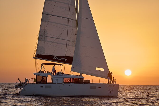 Santorini Oia: Private Sunset Catamaran Cruise with BBQ & Drinks - The lighthouse and southern coast change the view