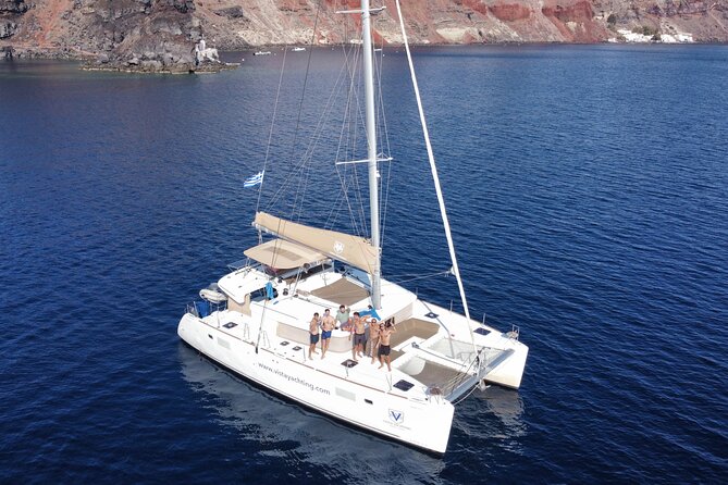 Santorini Platinum Catamaran Cruise with Meal, BBQ and Open Bar - The Akrotiri lighthouse adds a quiet landmark