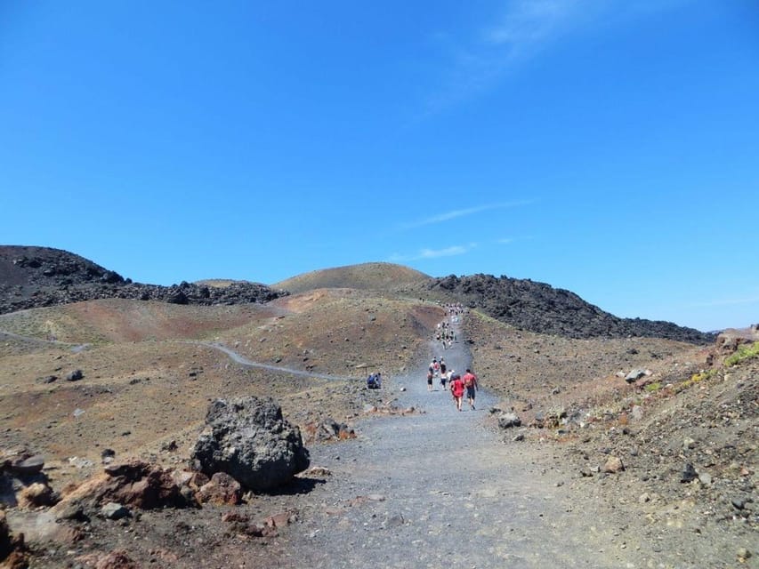 Santorini Port: 3 Hour Cruise to Volcano and Hot Springs - Sailing out beneath Santorini’s cliffs