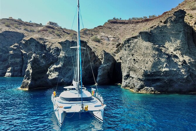 Santorini: Premium Small-Group Catamaran Cruise with Food/Drinks - Red Beach: volcanic cliffs and the first swim