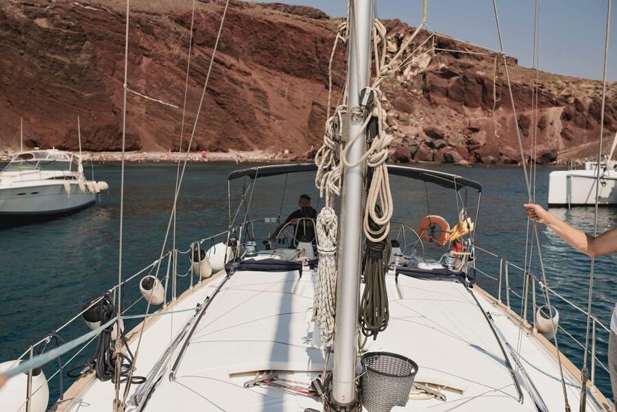 Santorini: Private 5-Hour Sunset Sailing Tour with Dinner - Timing, weather, and the return to Vlychada