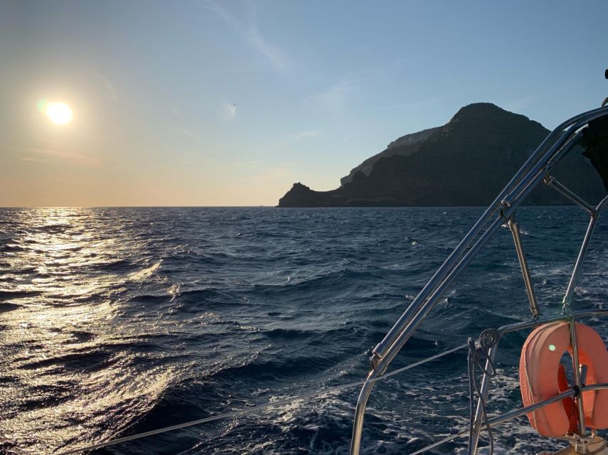 Santorini: Private 5-Hour Sunset Sailing Tour with Dinner - The lighthouse and the caldera crossing