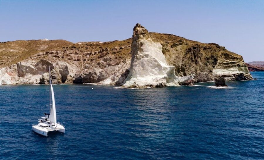 Santorini: Private Day Cruise with a BBQ meal and Open Bar - The lighthouse and the southern Caldera coast