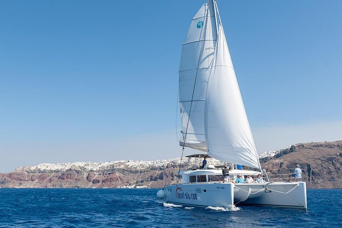 Santorini Small-Group Catamaran Sailing Trip(BBQ,drinks, transfer) - Red Beach: volcanic color and the first swim