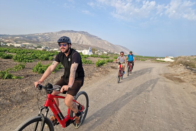 Santorini Small Group Guided E-bike Tour & Local Tomato Museum - Perissa’s black sand and volcanic character