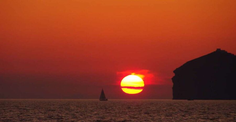 Santorini: Sunset Cruise with Greek Dinner and Transfer - Red Beach and White Beach from the sea