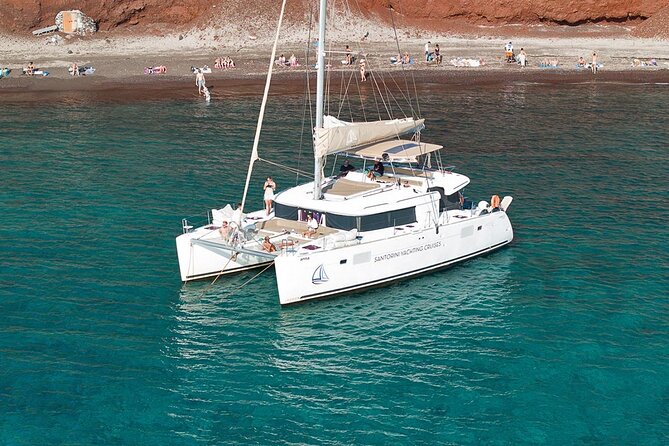 Santorini Sunset Sailing Cruise: Dinner, BBQ, Open Bar, Transfers - Red Beach gives the afternoon its first swim