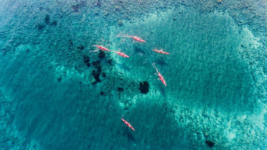 Santorini: Sunset Sea Kayak with Light Dinner - Sea caves and the Black Mountain sunset