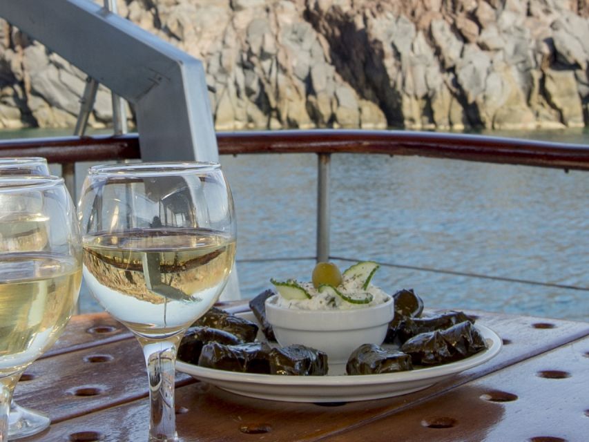 Santorini: Traditional Wooden Boat Tour with Meal and Wine - Swimming near Black Mountain and the Akrotiri Lighthouse