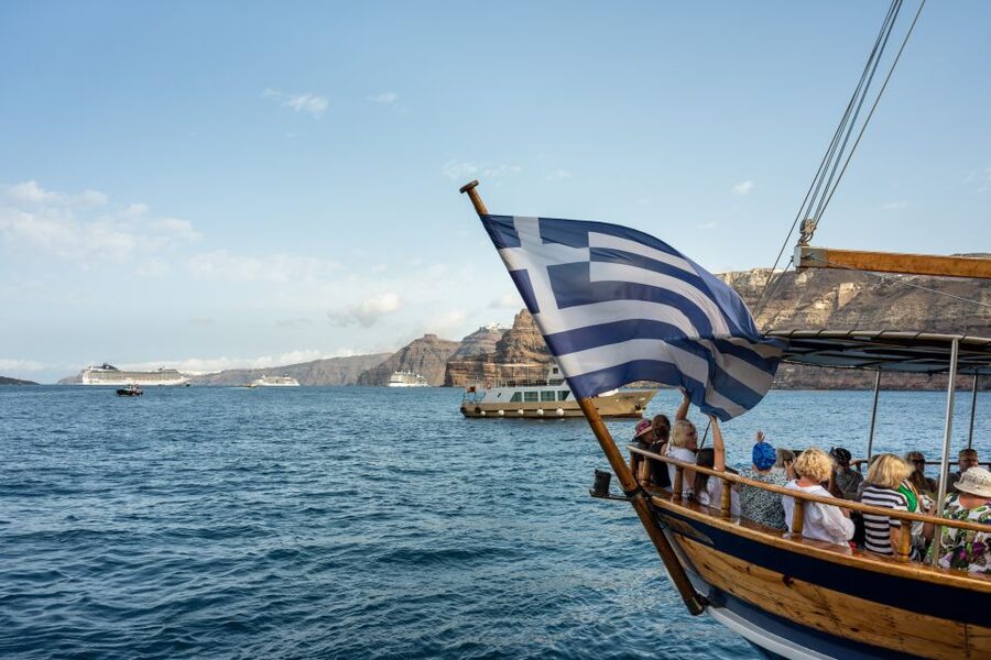 Santorini: Volcanic Islands Cruise with Hot Springs Visit - Cruising beneath Santorini’s cliffs