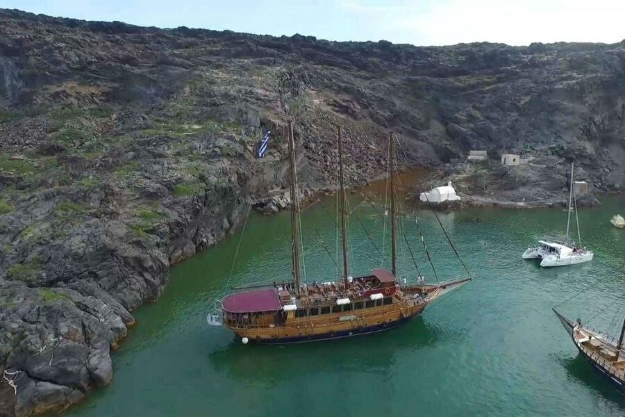 Santorini: Volcanic Sunset Cruise with Dinner - Leaving Athinios Port on a wooden caique