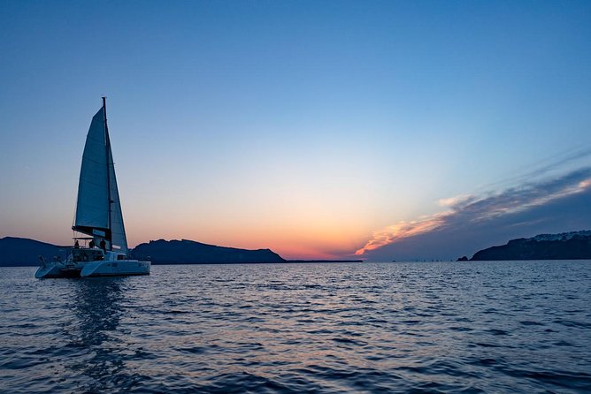 Sunset Cruise with BBQ and Drinks - Leaving Fira for the volcanic coast